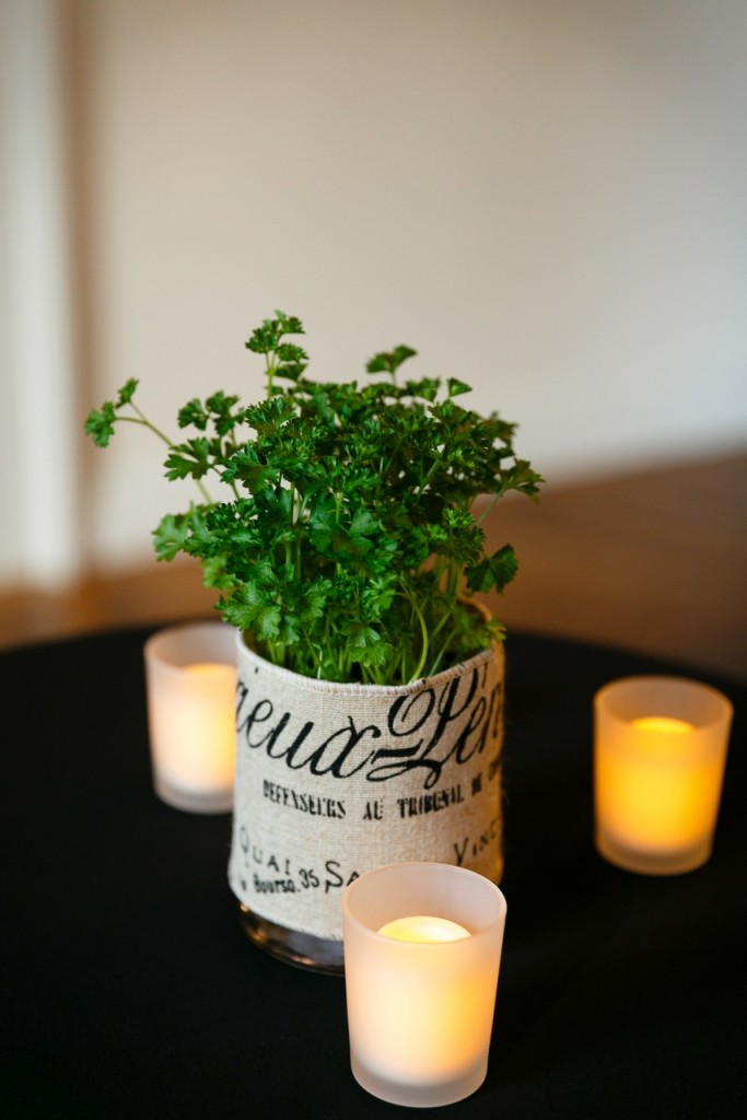 Potted parsley is wrapped in French burlap for a French farmers market centerpiece for wedding without flowers
