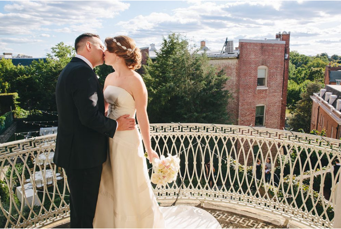 Bride and groom on balcony at Wilson House wedding