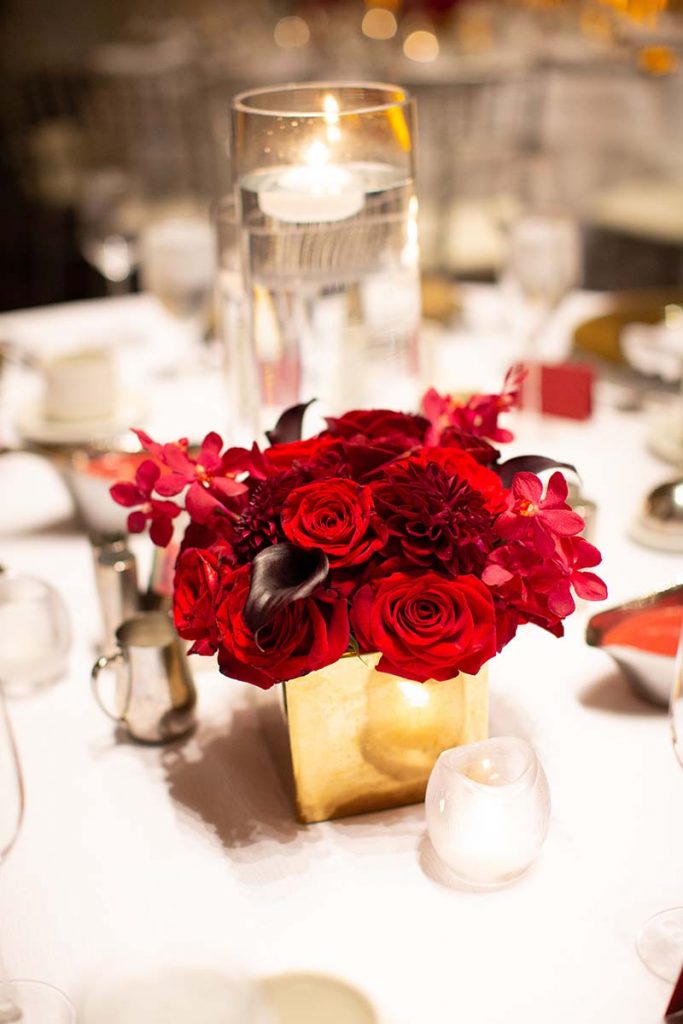 Red flowers in gold vase