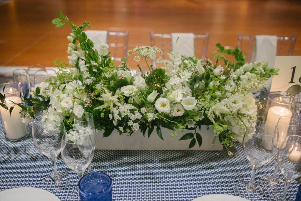 White boxes overflowing with white and green blooms