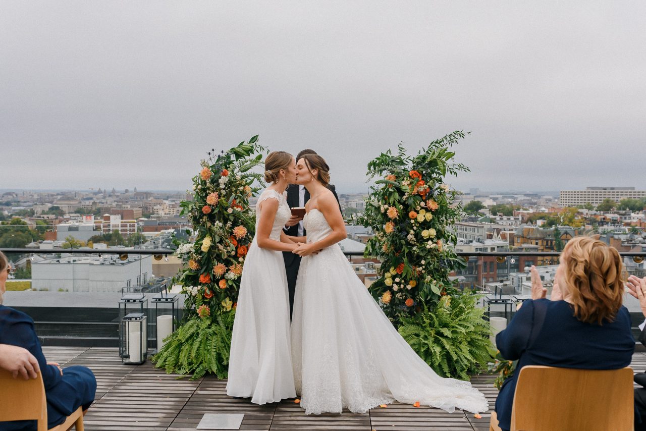 Two brides before deconstructed arch at LINE Hotel DC wedding